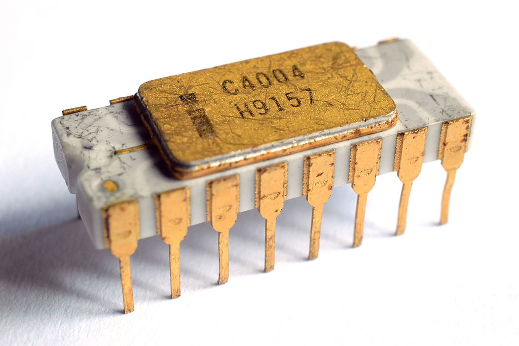 A photograph of a gold-legged intel 4004 processor, in an 8 wide DIP package